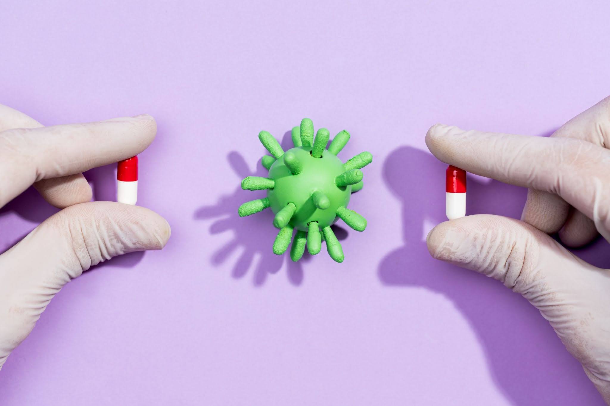Antimicrobial Resistance and Hospital Pathogens Gloved hands holding antibiotic pills beside a resistant pathogen, representing antimicrobial resistance